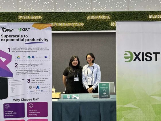 Two employees of Exist behind an event booth at the ADB Asia Pacific Digital Transformation Forum 2025