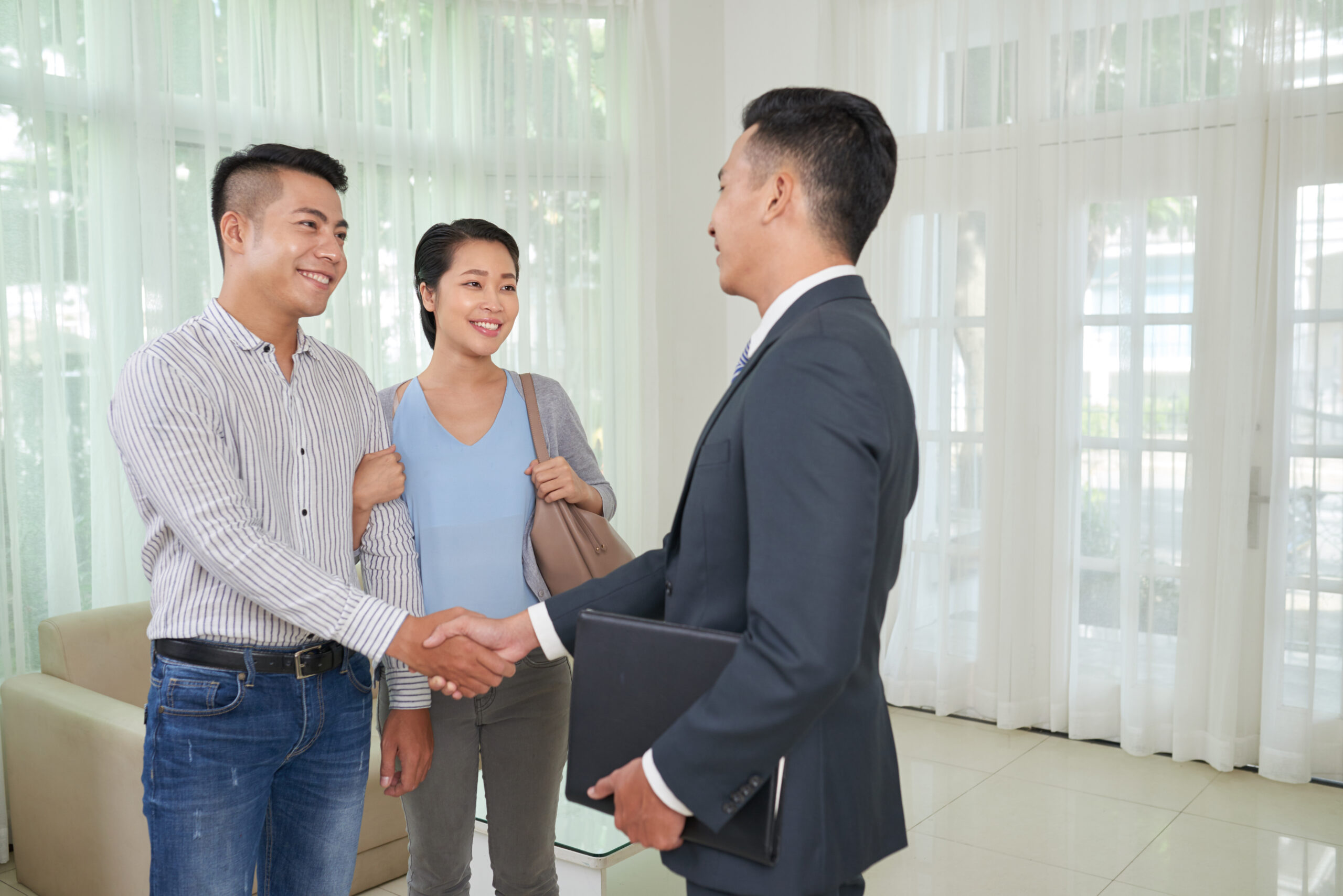 loan approval success featuring a couple and a banker