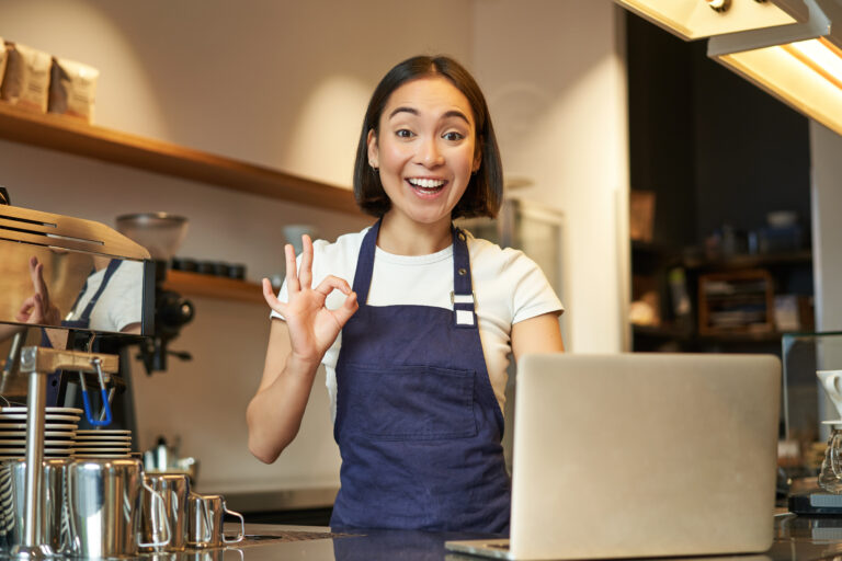 Happy cashier in cafe